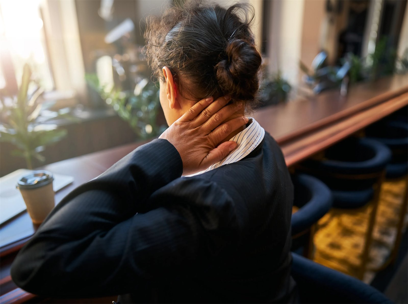 Woman holding her neck in discomfort